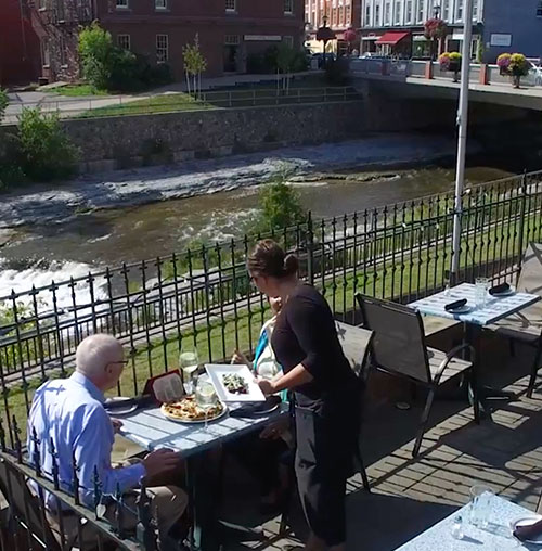 People dining overlooking the Ganaraska River