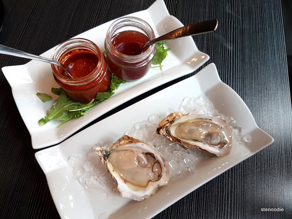 PEI oysters (2) plated with the accompanying sauces.