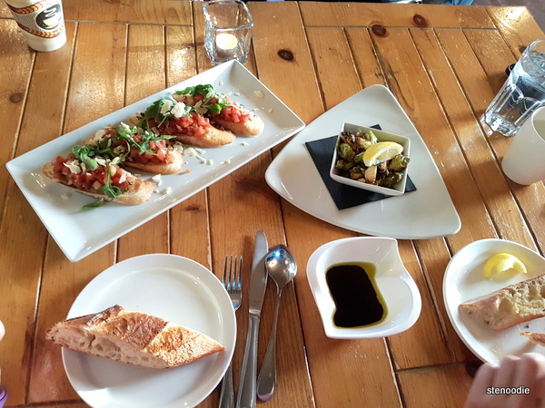 Bruschetta along with bread that is paired with balsamic vinegar