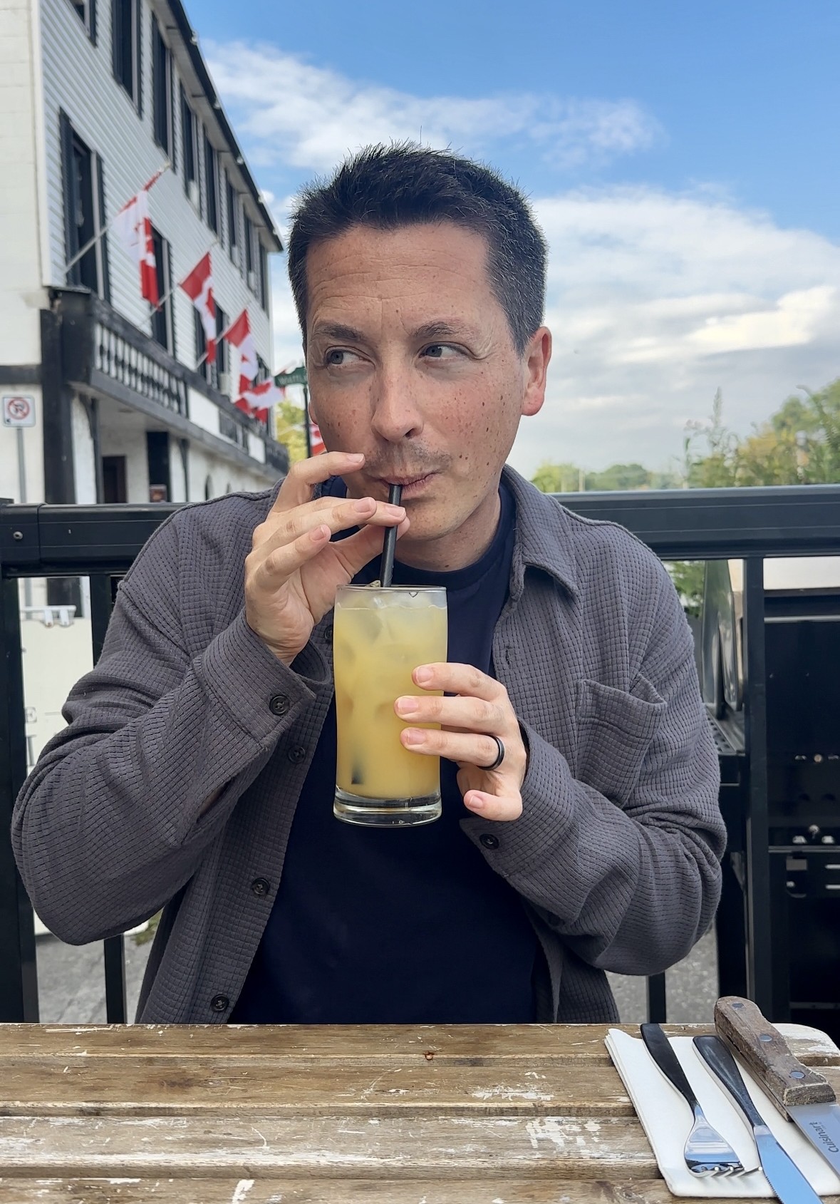 man sipping cocktail
