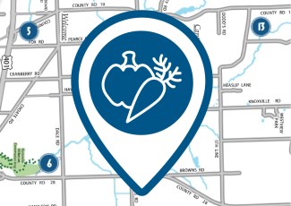 A pin icon of a pepper and a carrot in front of a digital map.
