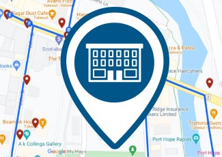 A pin icon of a historical two-storey building in front of a digital map.