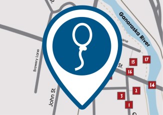 A pin icon of a balloon in front of a digital map.