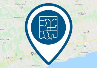 A pin icon of a base map in front of a digital map.