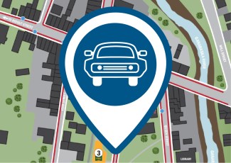 A pin icon of a car in front of a digital map.