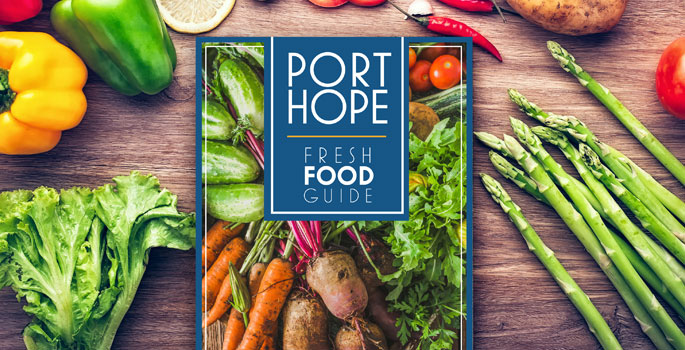 Port Hope's Fresh Food Guide brochure on table surrounded by vegetables