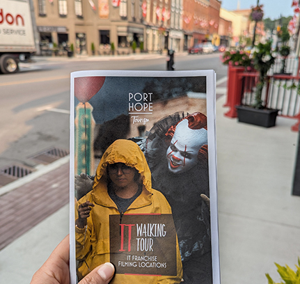 Person holding up IT walking tour on Walton