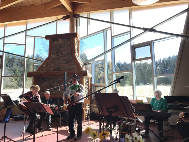 A band plays inside the lodge which boasts a large stone fireplace and full picture windows