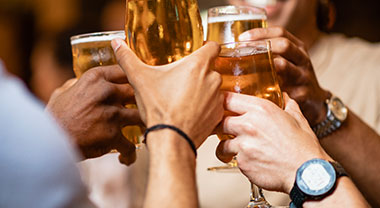 Group of friends raising beer glasses