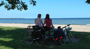 Women overlooking Lake Ontario with bikes on the Waterfront Trail in Port Hope