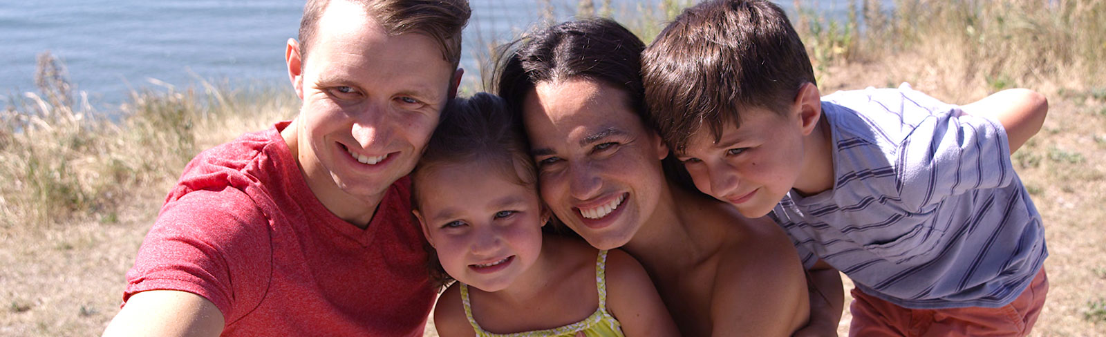 Family taking a photo together at beach