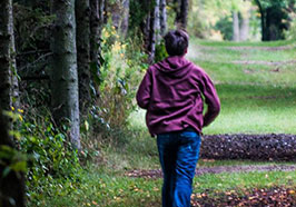 Boy hiking on a trail