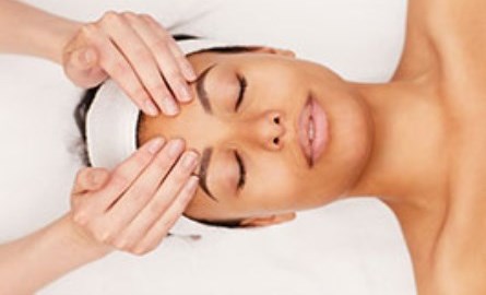 A woman getting a face massage