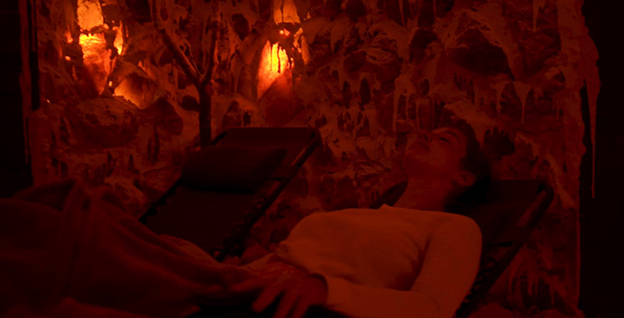 A woman relaxing in a salt cave.