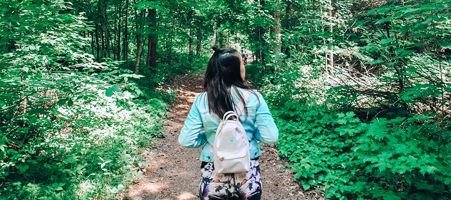 girl walking through forest