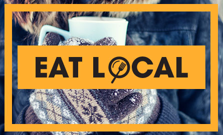 Eat Local logo in front of someone holding a mug