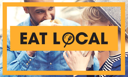 Eat Local logo in front of a family eating