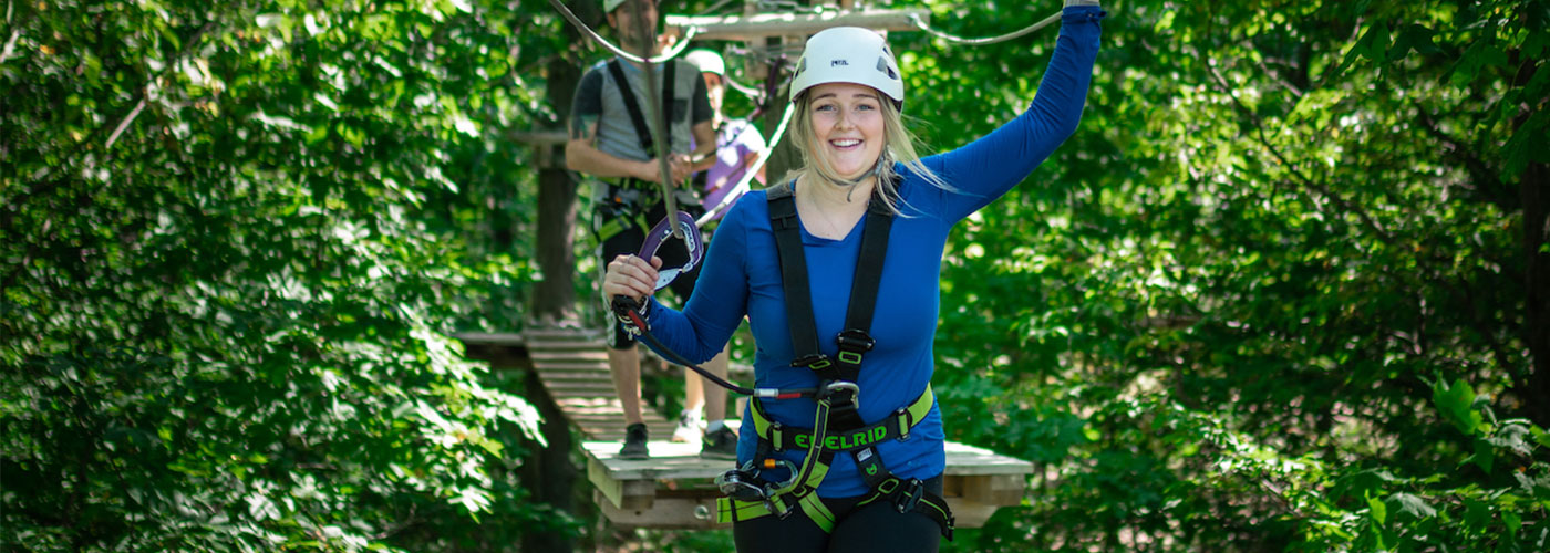 Woman performing the aerial treetop course.