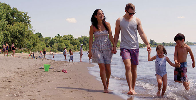 Family enjoying sandy East Beach in Port Hope